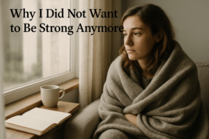 A young woman wrapped in a soft grey blanket sits quietly by a window, gazing outside with a tired, thoughtful expression. A mug and open journal rest beside her, capturing a peaceful yet emotionally heavy moment of reflection. Why I Did not Want to Be Strong Anymore