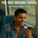 A young Indian man using voice input on his smartphone while traveling on a train, illustrating the impact of AI on travel in India — from voice notes to UPI. The image visually represents the concept behind the title How AI Is Changing the Way Indians Travel: From Voice Notes to UPI